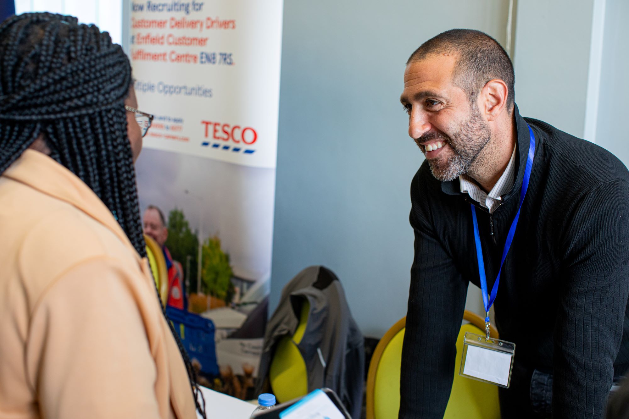 Decorative: Employer smiling and talking to person looking for work