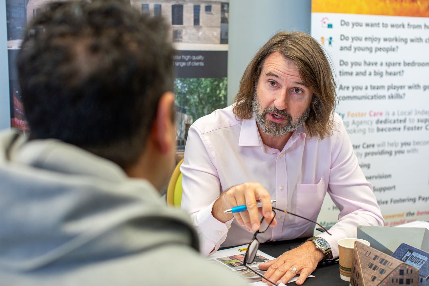 Enfield Jobs Fair 1 RooFF Decorative: Man from Rooff talking to job seeker