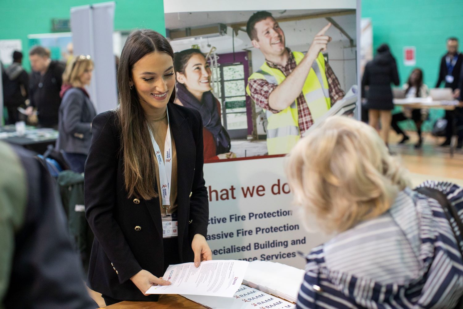 Decorative: woman speaking to job seeker at one of our recruitment fairs