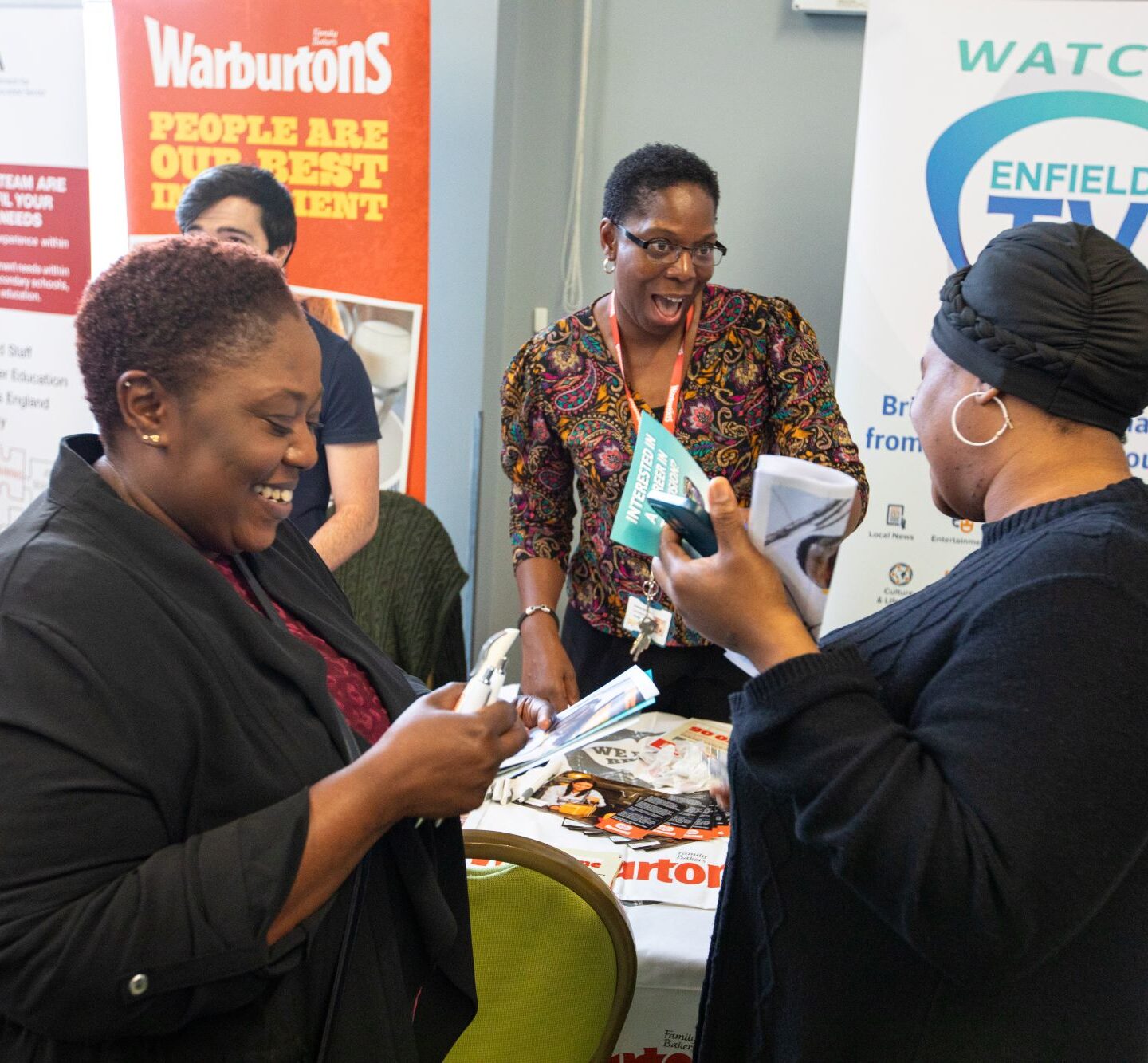 Enfield Recruitment Fair 2025 ladies laughing Decorative: ladies laughing and talking at one of our jobs fairs
