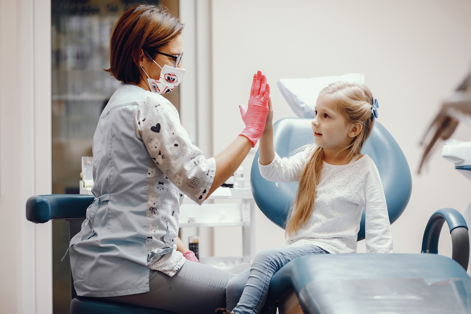 Health worker and child high fiving