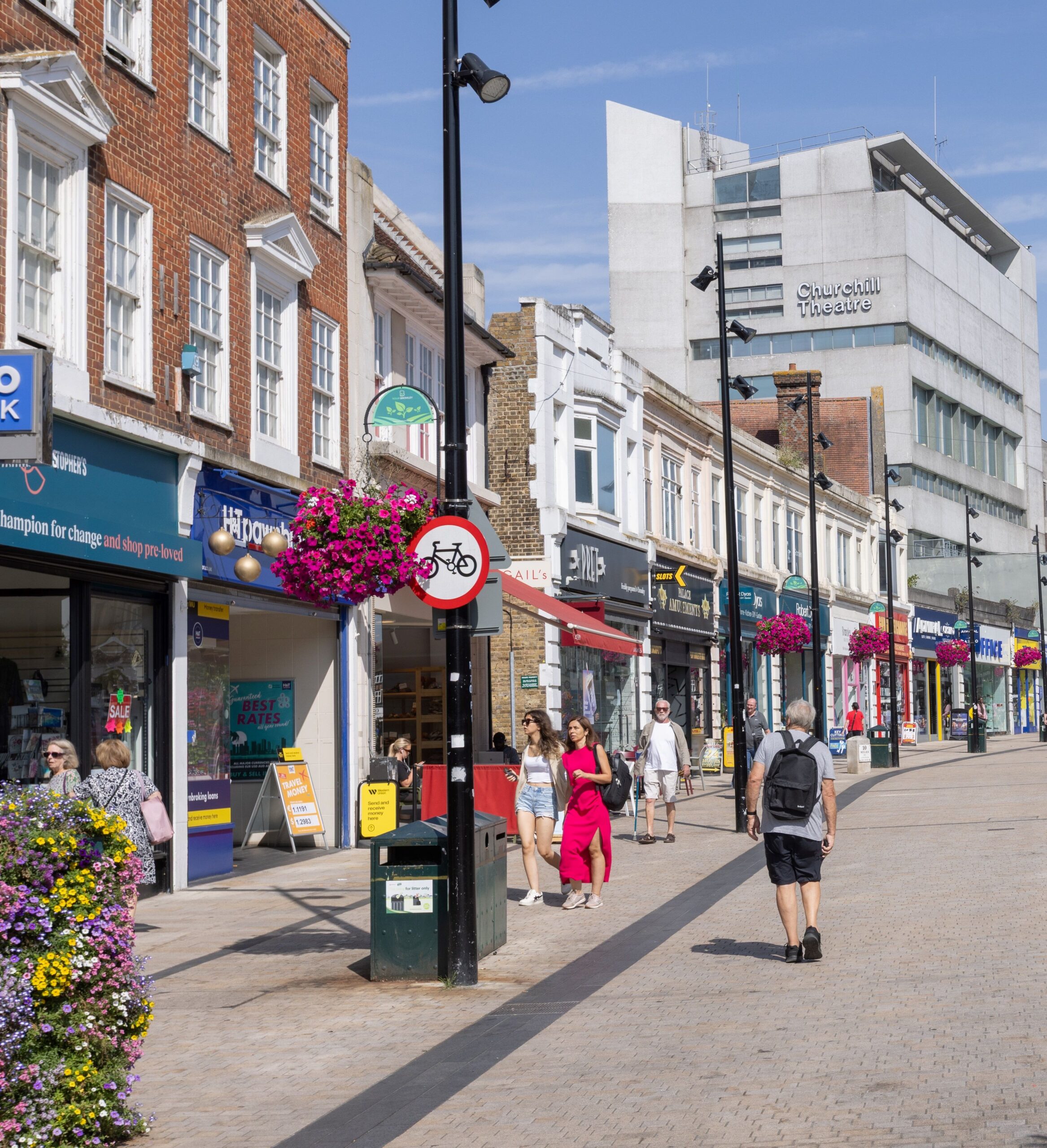 Photo of Bromley High Street and Churchill Theatre with people walking about enjoying sunny day.