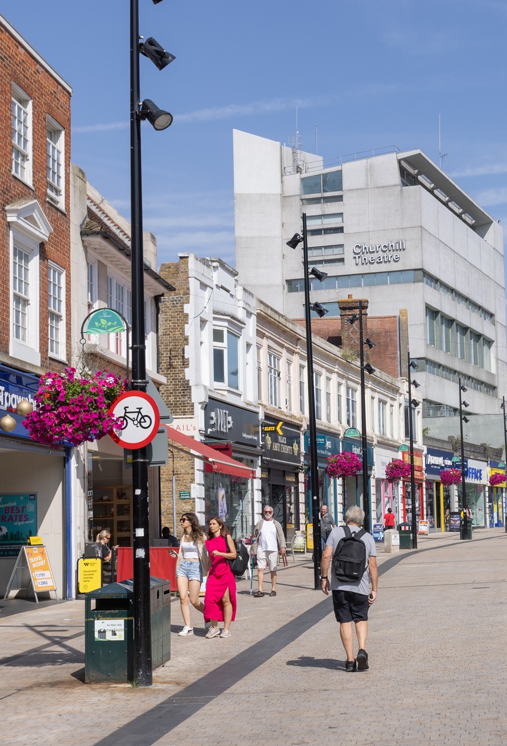 People enjoying a summers day in Bromley High Street with Churchill Theatre behind