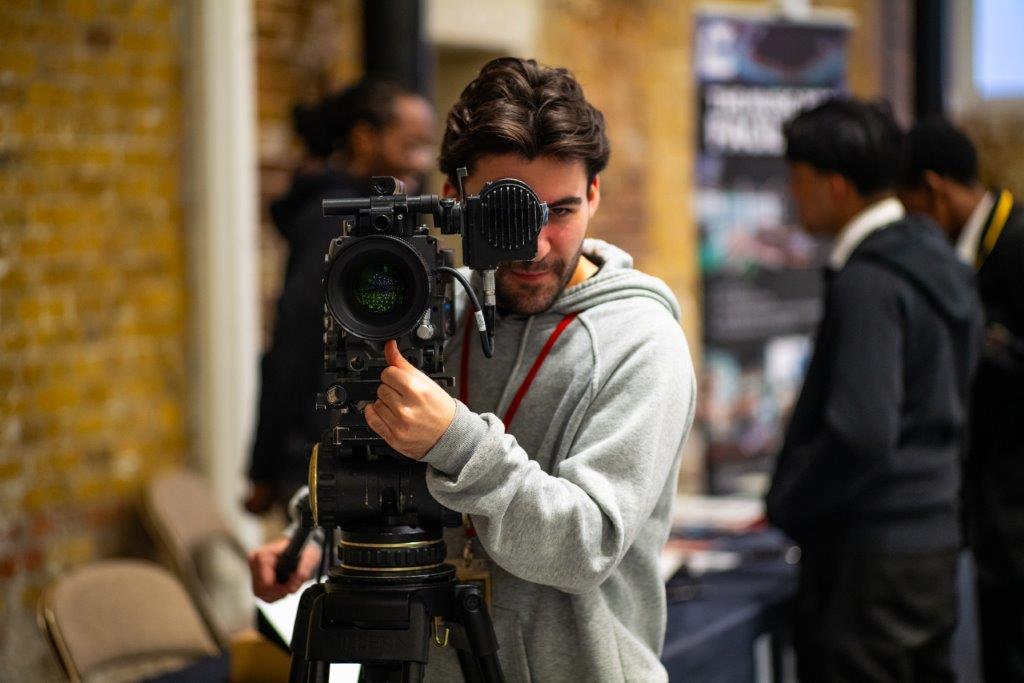 Videographer pointing a film camera at our careers and sustainability summit