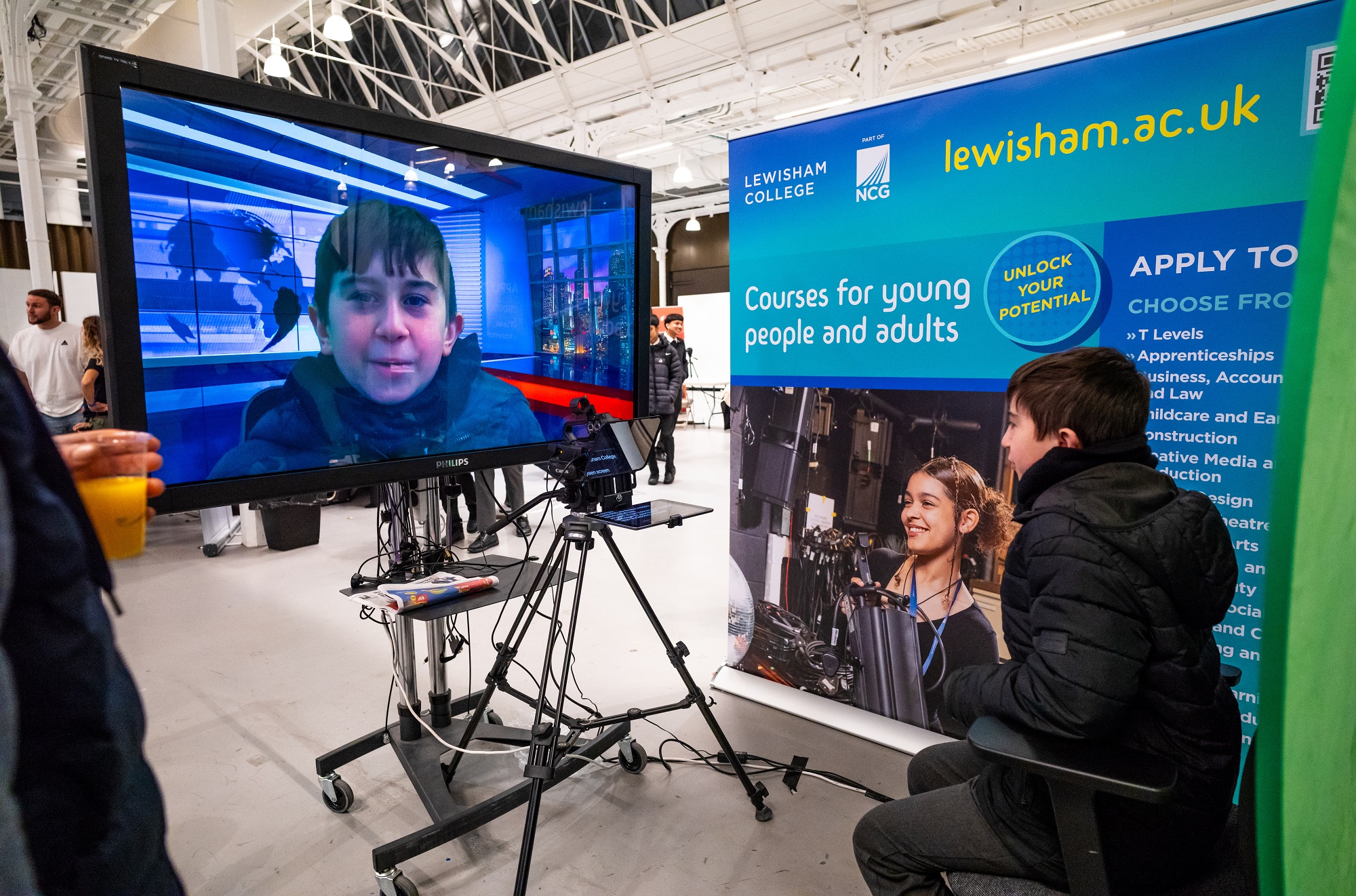 07Mar24_CreditUpstartProductions_LewishamCollege_2000x1300 Decorative: boy trying out reading from a teleprompter at one of our careers fairs.